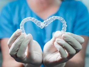 Invisalign aligners sitting on a glass surface