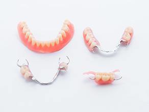 Partial and full dentures on white background